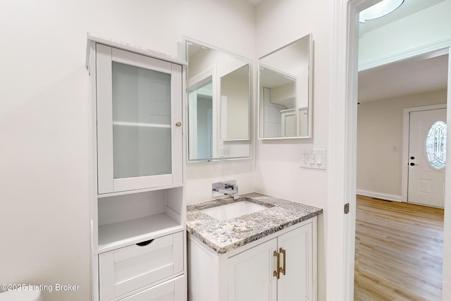 bathroom with vanity and hardwood / wood-style floors