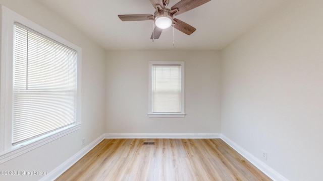 spare room with light hardwood / wood-style flooring, plenty of natural light, and ceiling fan