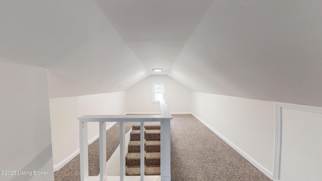 bonus room with lofted ceiling and carpet floors