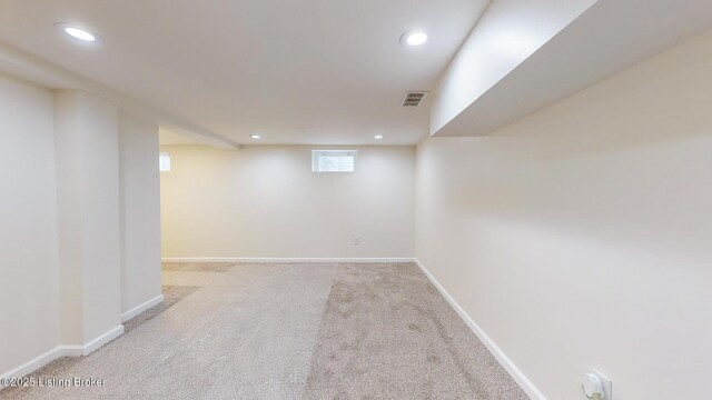 basement featuring light carpet