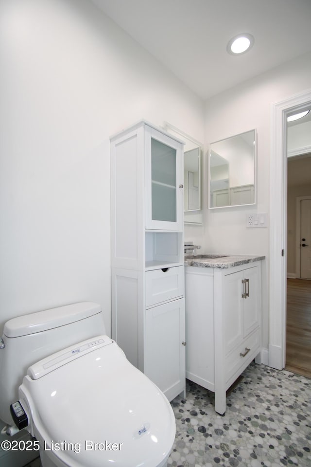 bathroom featuring vanity and toilet