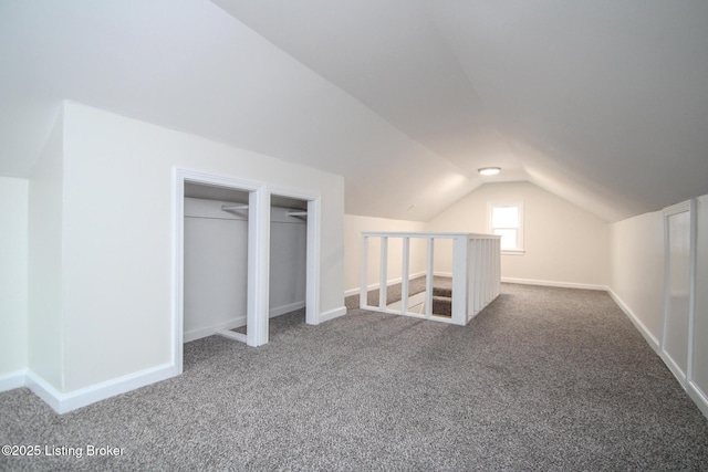 bonus room with vaulted ceiling and carpet