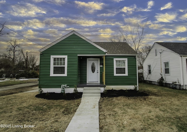 bungalow-style house with a yard