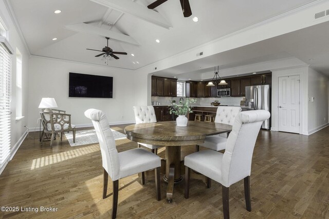 dining area featuring lofted ceiling with beams, a ceiling fan, visible vents, and dark wood-style flooring