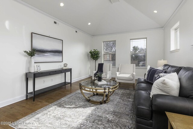 living area with visible vents, crown molding, baseboards, lofted ceiling, and wood finished floors