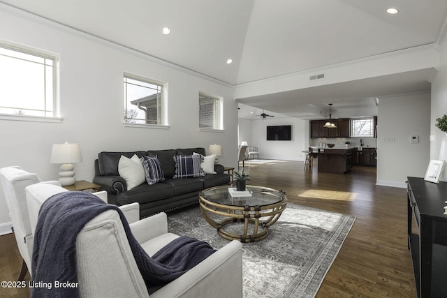 living area featuring dark wood finished floors, visible vents, and crown molding