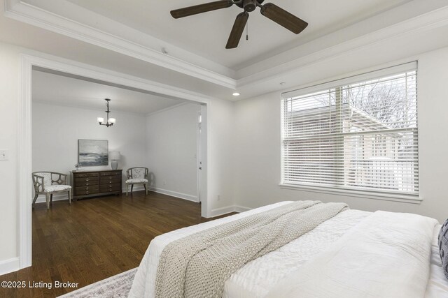 bedroom featuring a notable chandelier, crown molding, baseboards, and wood finished floors