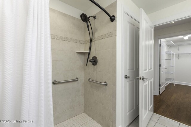 full bath featuring tile patterned floors and a stall shower