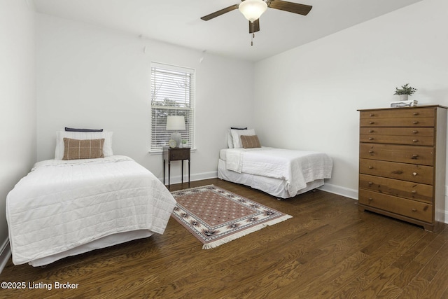 bedroom with baseboards, wood finished floors, and a ceiling fan