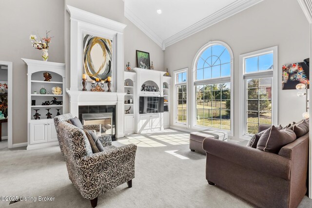 carpeted living room with vaulted ceiling, ornamental molding, and a tile fireplace