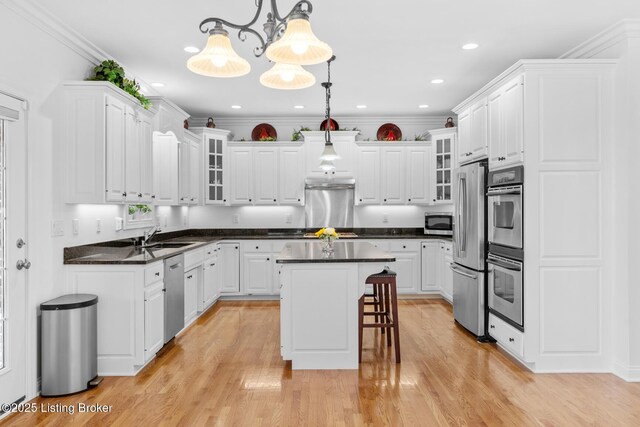 kitchen with appliances with stainless steel finishes, dark countertops, and white cabinets