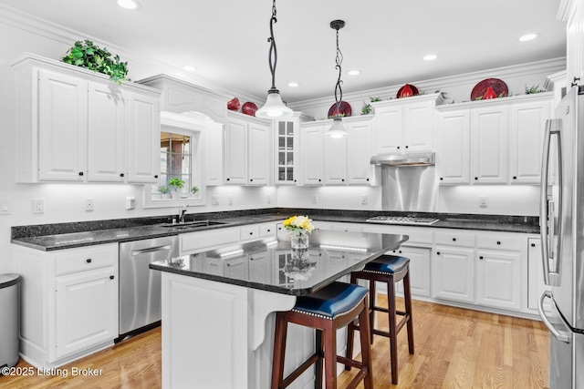 kitchen featuring stainless steel appliances, white cabinets, a sink, and under cabinet range hood