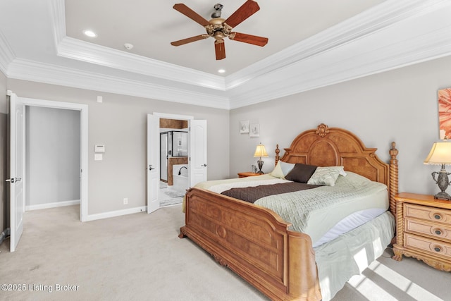 bedroom featuring a tray ceiling, light colored carpet, crown molding, and baseboards