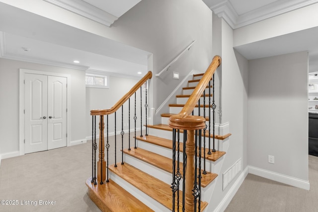 stairway featuring carpet floors, baseboards, visible vents, and crown molding