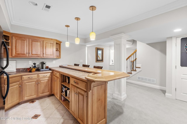 kitchen with open shelves, ornamental molding, a peninsula, and visible vents