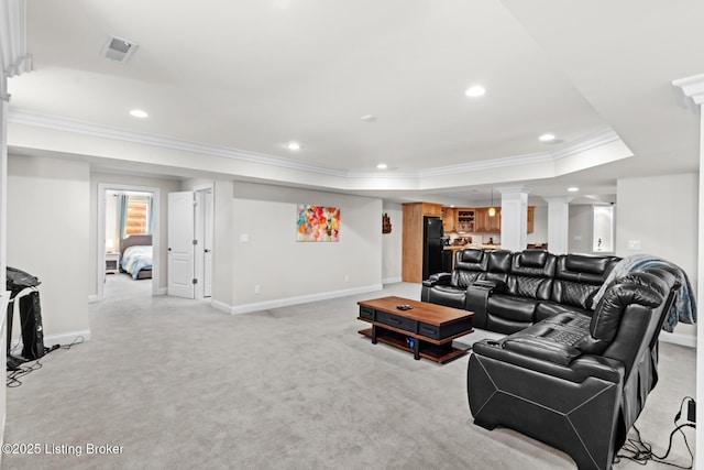 living room with recessed lighting, light colored carpet, ornamental molding, a tray ceiling, and ornate columns