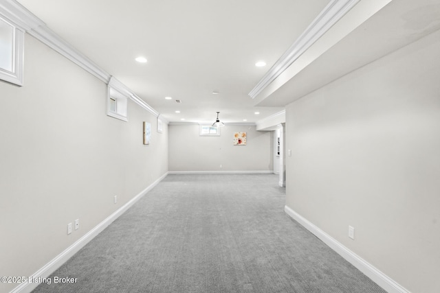 basement featuring light carpet, baseboards, ornamental molding, and recessed lighting