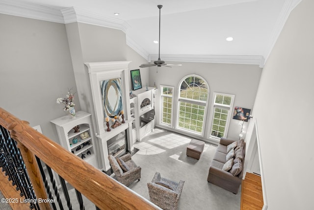 living room with recessed lighting, a fireplace, wood finished floors, a ceiling fan, and crown molding