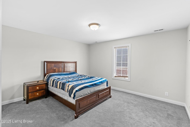 carpeted bedroom with visible vents and baseboards