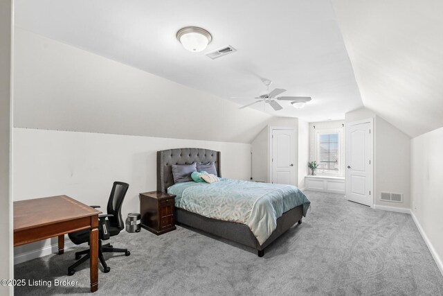 carpeted bedroom with lofted ceiling, baseboards, visible vents, and a ceiling fan