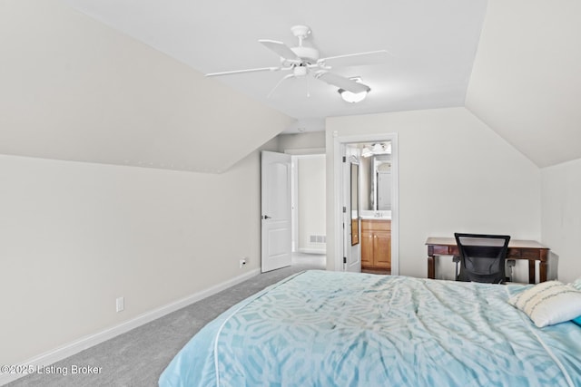 bedroom with connected bathroom, visible vents, baseboards, vaulted ceiling, and carpet