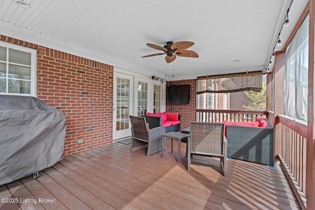 wooden terrace featuring ceiling fan and an outdoor hangout area