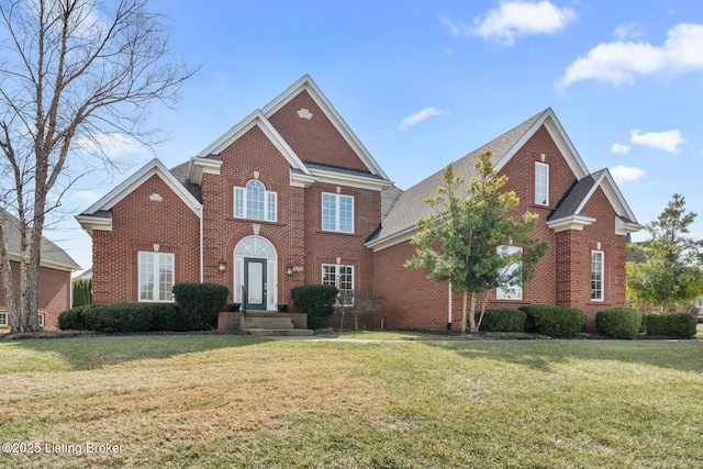 view of front of home featuring a front yard and brick siding