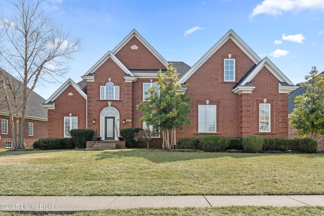 view of front of home with brick siding and a front lawn