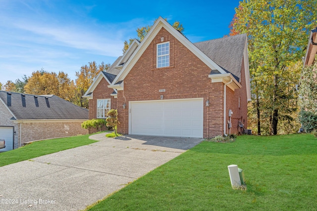 view of front of house with a garage and a front lawn