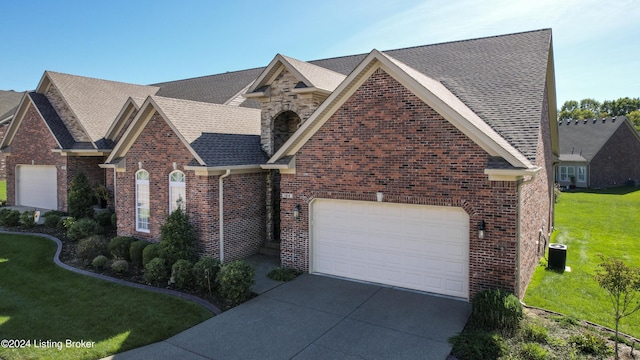 view of front of property with a garage and a front lawn