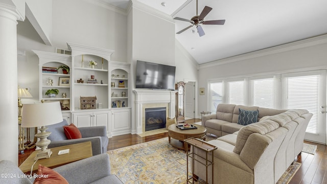 living room with ceiling fan, ornamental molding, dark hardwood / wood-style flooring, and high vaulted ceiling