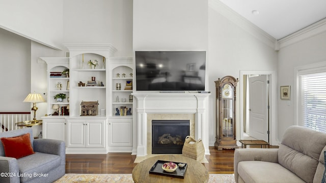 living room featuring high vaulted ceiling, a high end fireplace, ornamental molding, and dark hardwood / wood-style floors