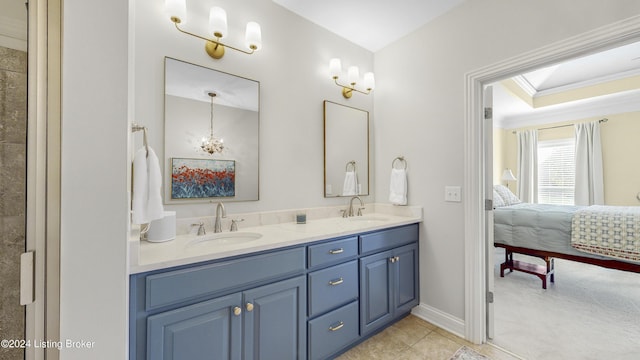 bathroom with tile patterned floors, ornamental molding, and vanity