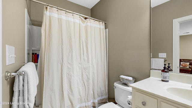 bathroom featuring vanity, toilet, and a shower with shower curtain