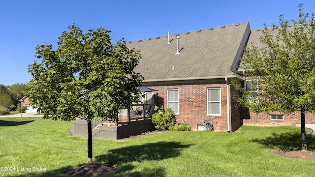 back of property featuring a lawn