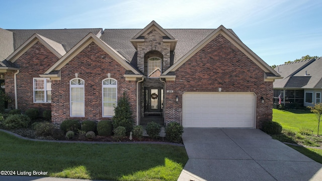 view of front of property with a garage and a front lawn