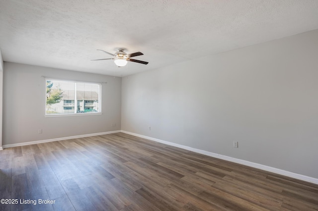 spare room featuring ceiling fan, dark hardwood / wood-style floors, and a textured ceiling