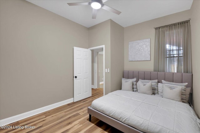 bedroom with light hardwood / wood-style flooring and ceiling fan