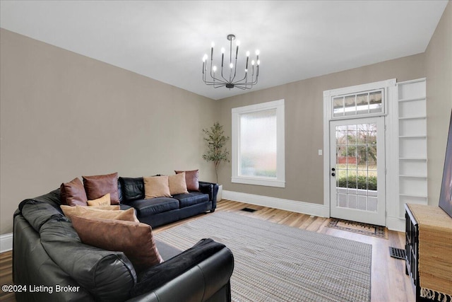 living room featuring an inviting chandelier and light hardwood / wood-style floors