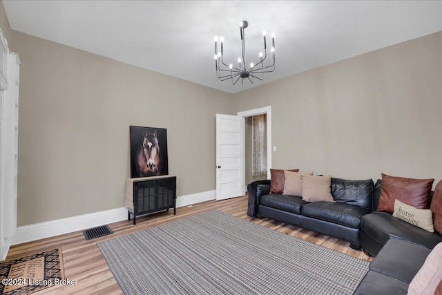 living room with wood-type flooring and a chandelier