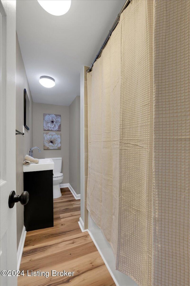 hallway featuring hardwood / wood-style flooring and sink