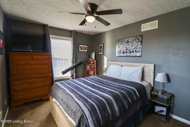 carpeted bedroom with ceiling fan and a textured ceiling