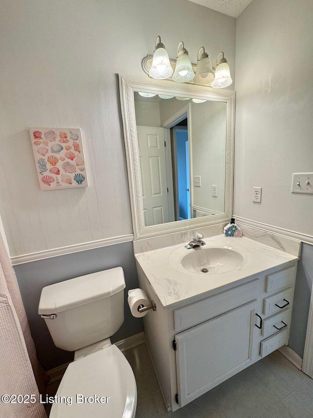 bathroom featuring vanity and toilet