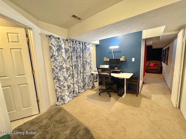 office space with light colored carpet and a textured ceiling