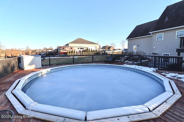 view of swimming pool featuring a hot tub and a wooden deck