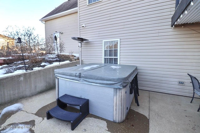 snow covered patio with a hot tub