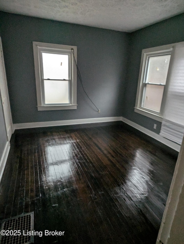 empty room featuring dark hardwood / wood-style floors