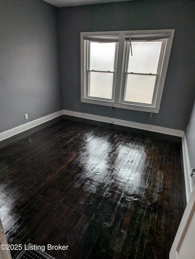 empty room featuring dark wood-type flooring