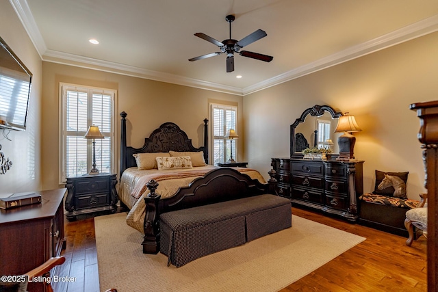 bedroom with ceiling fan, ornamental molding, and dark hardwood / wood-style flooring