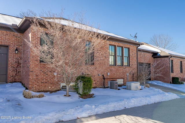 view of snow covered exterior featuring a garage